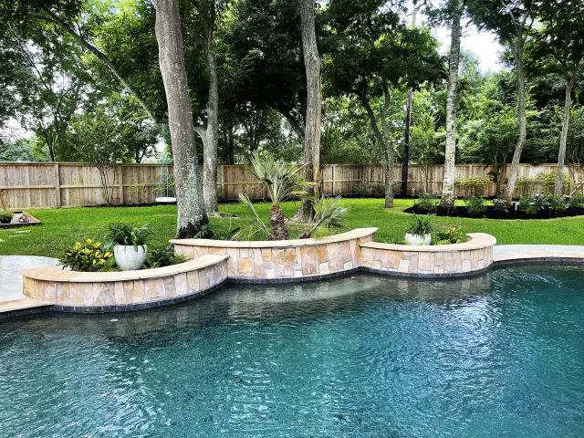 Raised planter curve over the pool
